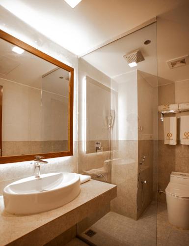 a bathroom with a sink and a shower at The Royal Palace Uttara in Dhaka