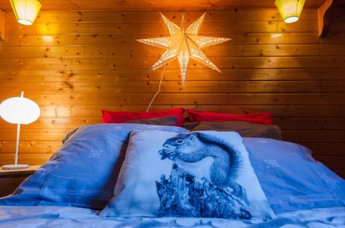 a bed with a picture of a dinosaur on it at Chalet L'imprévu in Vaulnaveys-le-Bas
