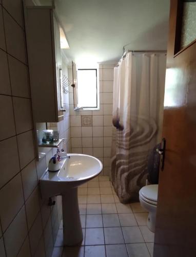 a bathroom with a sink and a shower and a toilet at Zarakas home in Monemvasia