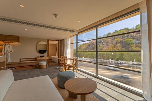 a living room with a large window at Riva Hua Hin in Ban Khao Takiap