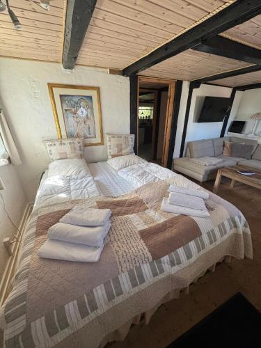 a large bed in a room with towels on it at Conedue B&B in Væggerløse