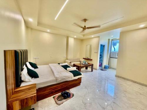 a bedroom with a bed and a living room at Shree Krishna Palace Hotel - Couple Friendly in Lucknow