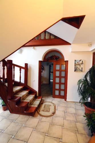 a house with a staircase leading to theoyer at Rapsodia Pension in Suceava