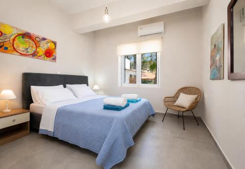 a bedroom with a bed and a chair and a window at Villa Memories in Palaiochora