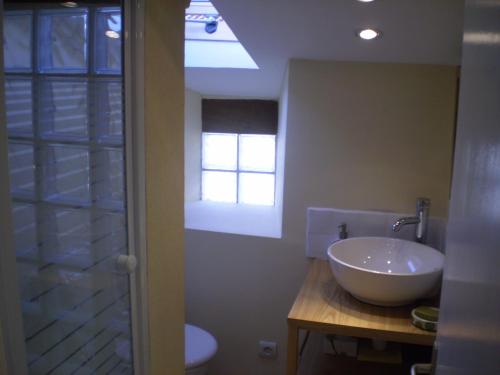 La salle de bains est pourvue d'un lavabo et d'une fenêtre. dans l'établissement Peach Cottage, à La Forêt-sur-Sèvre