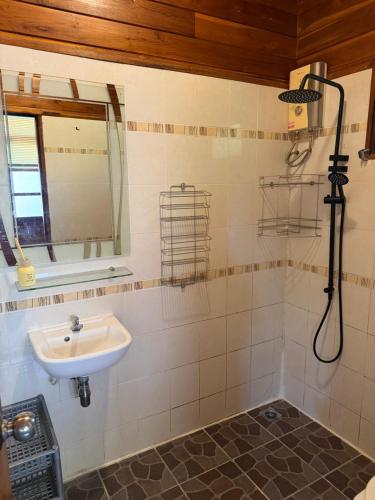 a bathroom with a sink and a shower at Golden Teak Resort Baan Sapparot in Kamala Beach