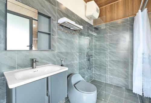 a bathroom with a sink and a toilet at Luxury Hotel Dalat in Xuan An