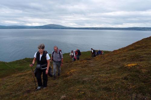 a group of people walking on a hill near a body of water at Dufferin Coaching Inn in Killyleagh