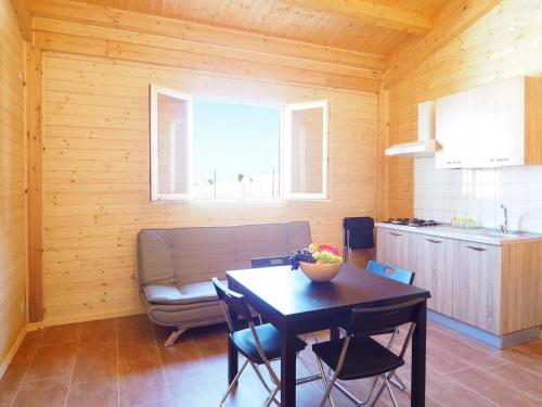 a kitchen and dining room with a table and a couch at Agriturismo Paparanza in Valguarnera Caropepe