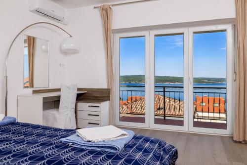 a bedroom with a bed and a view of the ocean at Apartment Tus A1 in Crikvenica