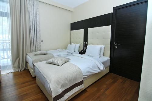 a hotel room with two beds and a window at Crowne Plaza - Borjomi by IHG in Borjomi