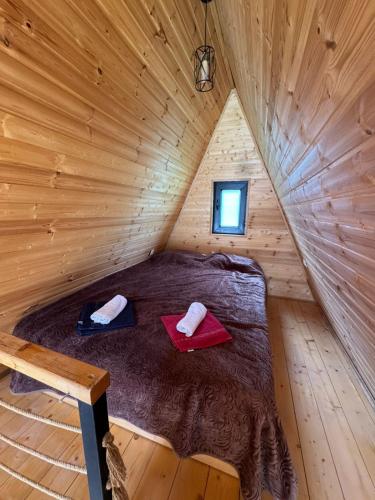 a bedroom in a log cabin with a bed in it at Hochaladah2 in Mestia