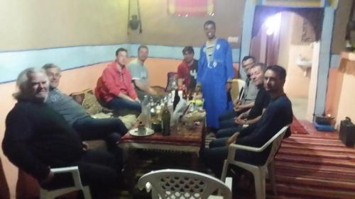 a group of men sitting around a table at Luna del fuego in Ifri