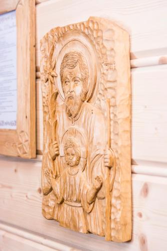 a wooden statue of a man with a child on a wall at U Dziadka in Chochołów