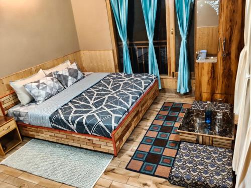 a bedroom with a bed and a window with blue curtains at The Morchella House Tirthan Valley in Gushaini