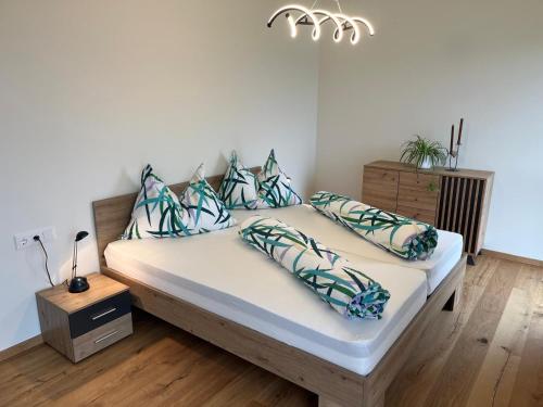 a bed with pillows on it in a room at Appartement Dürnle Reißeck in Mühldorf