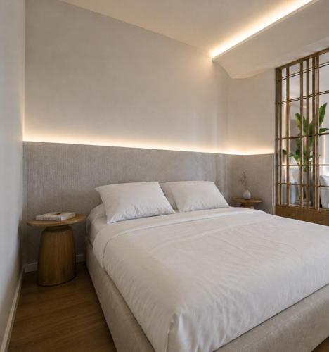 a bedroom with a white bed and a window at Harmony Hotel Nafplio in Nafplio