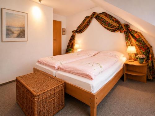 a bedroom with a bed with a canopy at Glaeßer Appartements in Burg auf Fehmarn