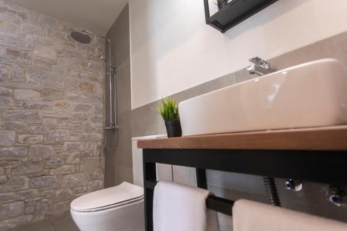 a bathroom with a sink and a toilet at ALLURE Luxury Villa One Skiathos in Skiathos