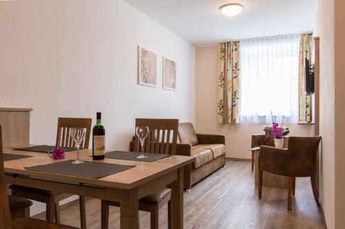 a living room with a table and a couch at Wasmayr Hof in Landshut