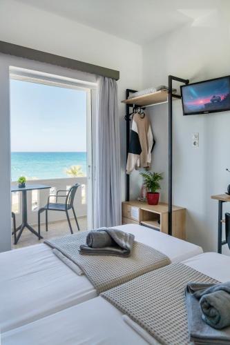 a bedroom with a bed with a view of the ocean at Star Apartments in Rethymno