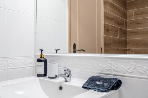a white bathroom with a sink and a mirror at Albufeira prime stay in Albufeira