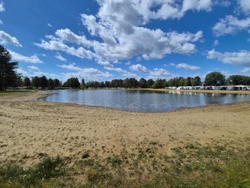 a view of a river with a sandy beach at Stellira - Vakantieverblijf in Zonhoven