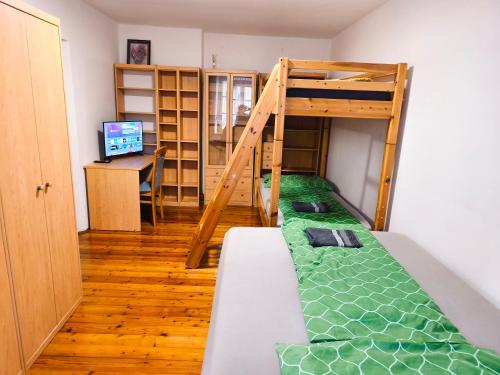 a bedroom with a bunk bed and a desk at Altstadthaus Marille mit Innenhofterrasse in Melk