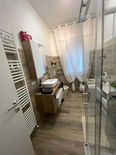a bathroom with a toilet and a sink and a shower at Casa Ezio beach&relax in Chioggia