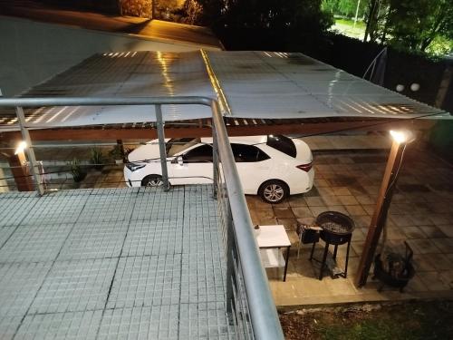 a white car parked under a garage at night at Nebel Apart in Concordia