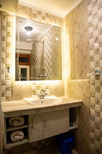 a bathroom with a sink and a mirror at Nag Pukhu Guest House in Bhaktapur