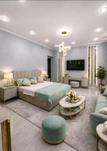a bedroom with a large bed and a living room at Taraz in Taraz