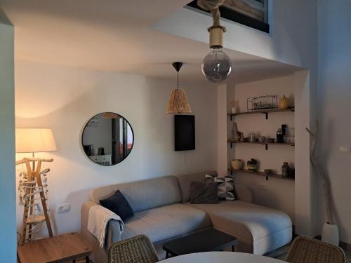 a living room with a couch and a mirror at Pine House Novalja in Gajac