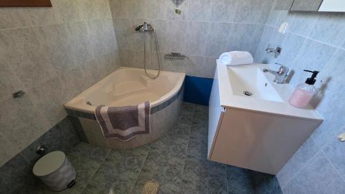 a bathroom with a tub and a sink and a toilet at Anemos House Sykia Halkidiki in Sykia Chalkidikis