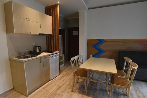 a small kitchen with a table and chairs in a room at Laida studios in Prinos