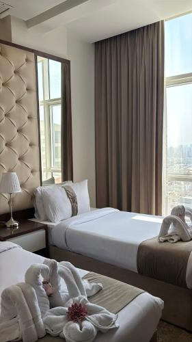 a hotel room with two beds with towels on them at Dolphin Continental Hotel in Kuwait