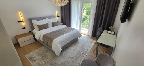 a bedroom with a large bed and a window at Guesthouse Čivljak in Baška Voda