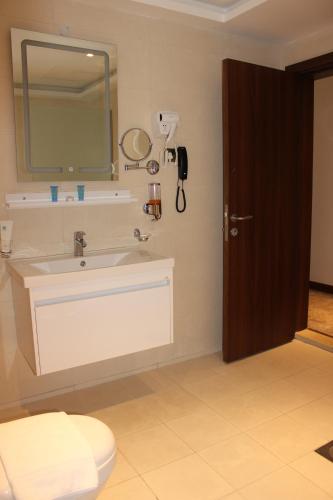 a bathroom with a sink and a mirror at Dolphin Continental Hotel in Kuwait