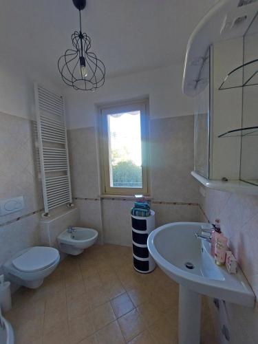 a bathroom with a toilet and a sink at Lake Iseo Apartment - Taxo4 in Paratico