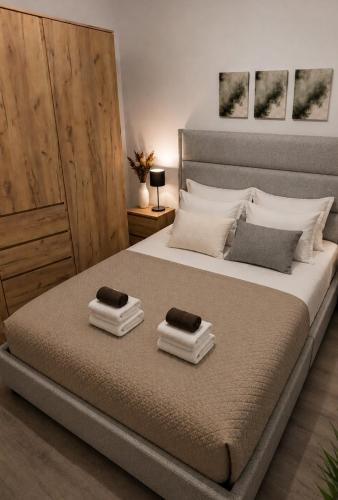 a bedroom with a bed with two towels on it at Helena's house in Ermoupoli
