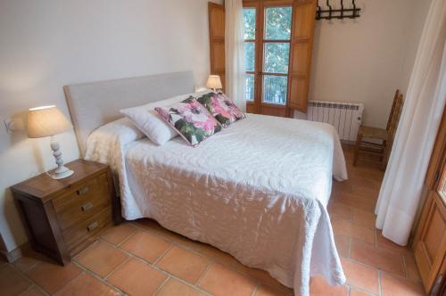 a bedroom with a bed with two pillows on it at Casa Rural El Riberer in Benissa