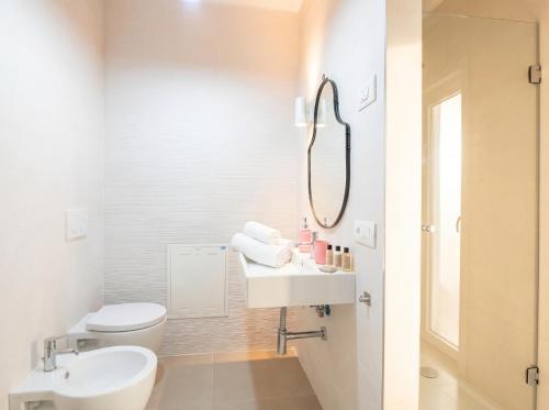 a white bathroom with a sink and a toilet at Dimora Anna - Exclusive Sea Loft in Bari