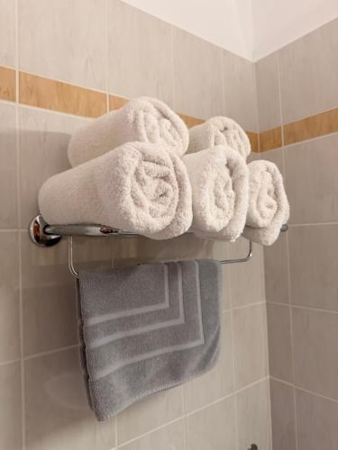 a bunch of towels on a towel rack in a bathroom at Hotel Lemnos in Myrina