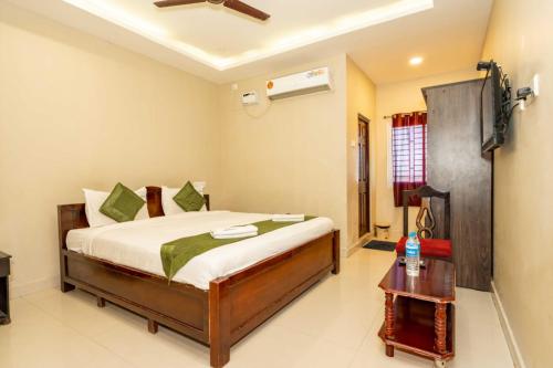 a bedroom with a bed and a television in it at Hotel Ramleela in Rāmeswaram