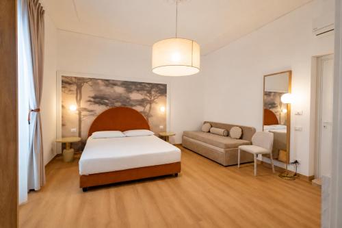 a hotel room with a bed and a couch at Lina's Room in Cinisi