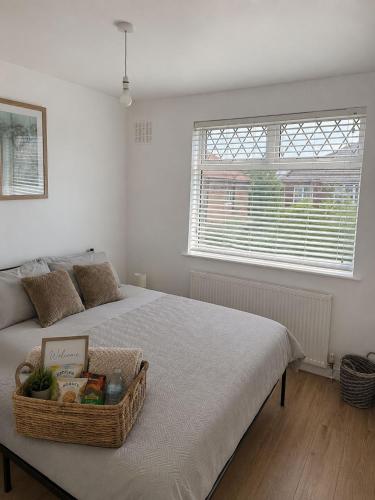 a bedroom with a bed with a basket on it at Stylish 4BR Home - Sleeps 7 - Parking & WiFi in Nottingham