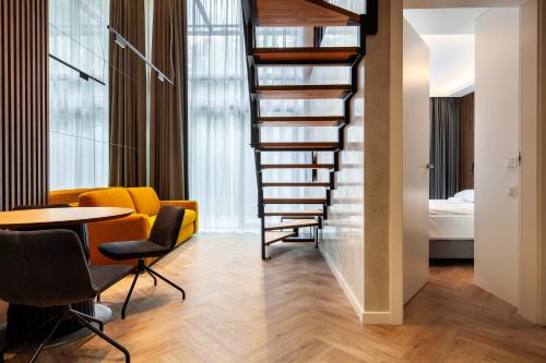 a staircase in a room with a table and a bed at Amber Elite Apartments in Stegna