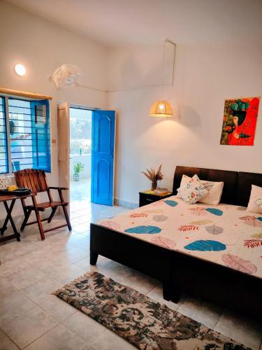 a bedroom with a bed and a table and chairs at Aranya Tara in Bhīm Tāl