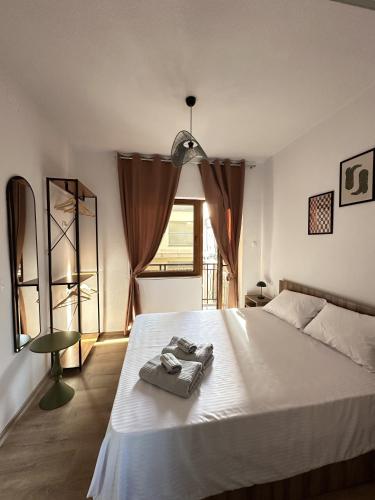 a bedroom with a bed with two towels on it at Legend Suites Bitola in Bitola
