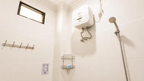 a shower in a bathroom with a shower head at Griya Mentari Homestay in Yogyakarta